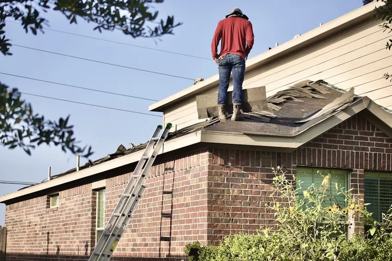 Professional roofer working on a residential roof in New Bedford